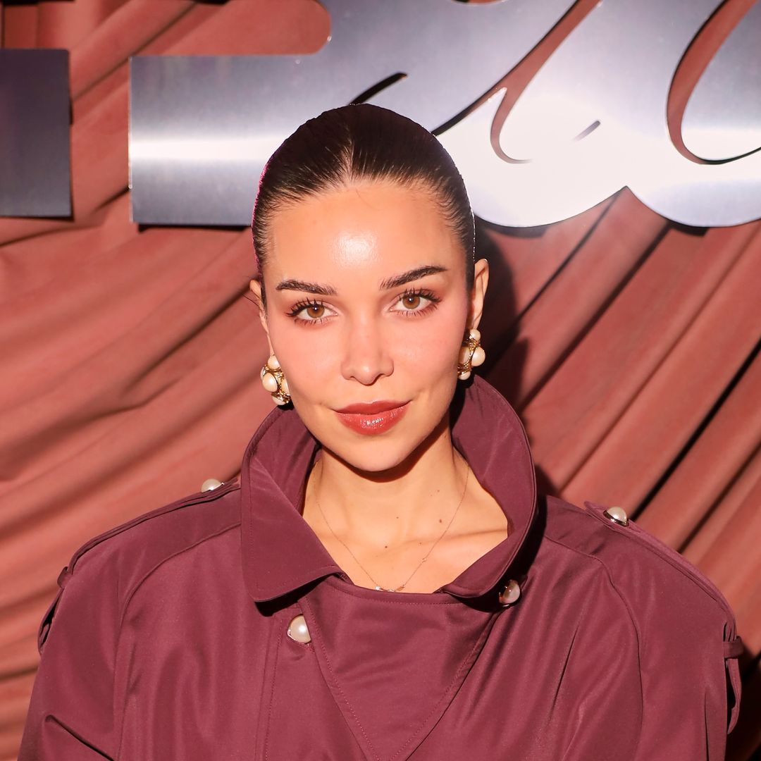Jackie Apostel takes cues from Victoria Beckham in oxblood trench coat and leather accessories